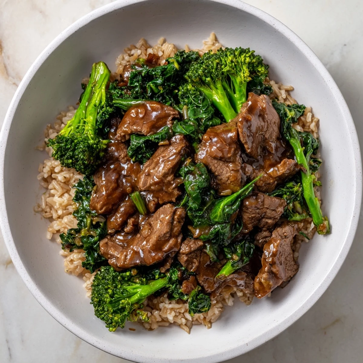 Tender slow-cooker Beef & Broccoli with glistening brown rice and fresh greens, a fully balanced meal.