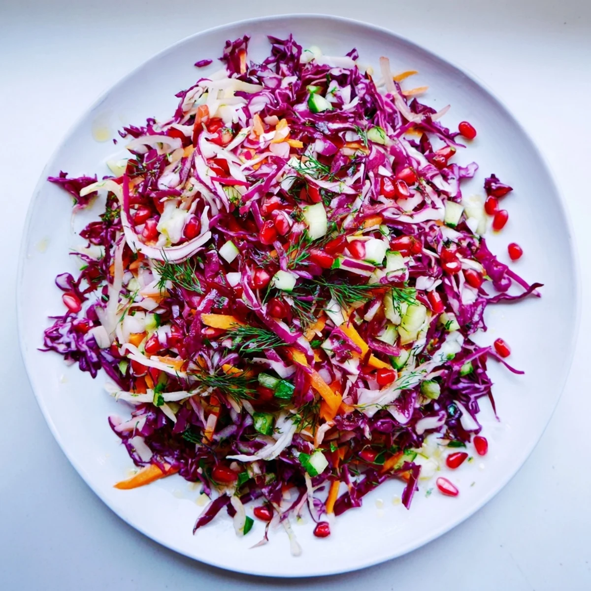 A close-up view of fresh Shirazi-Inspired Winter Slaw, showcasing bright dressing and herbs.