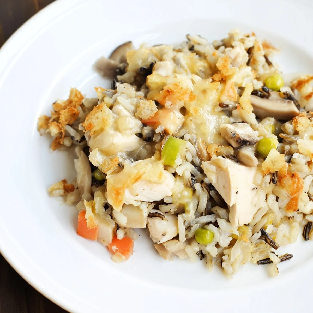 Golden brown Chicken and Wild Rice Bake, a hearty casserole steaming hot from the oven.