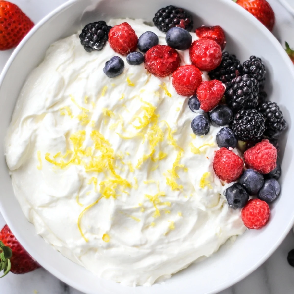 Fresh, juicy berries nestled around a bowl of irresistibly fluffy Cream Cheese Fruit Dip, ready to be enjoyed.