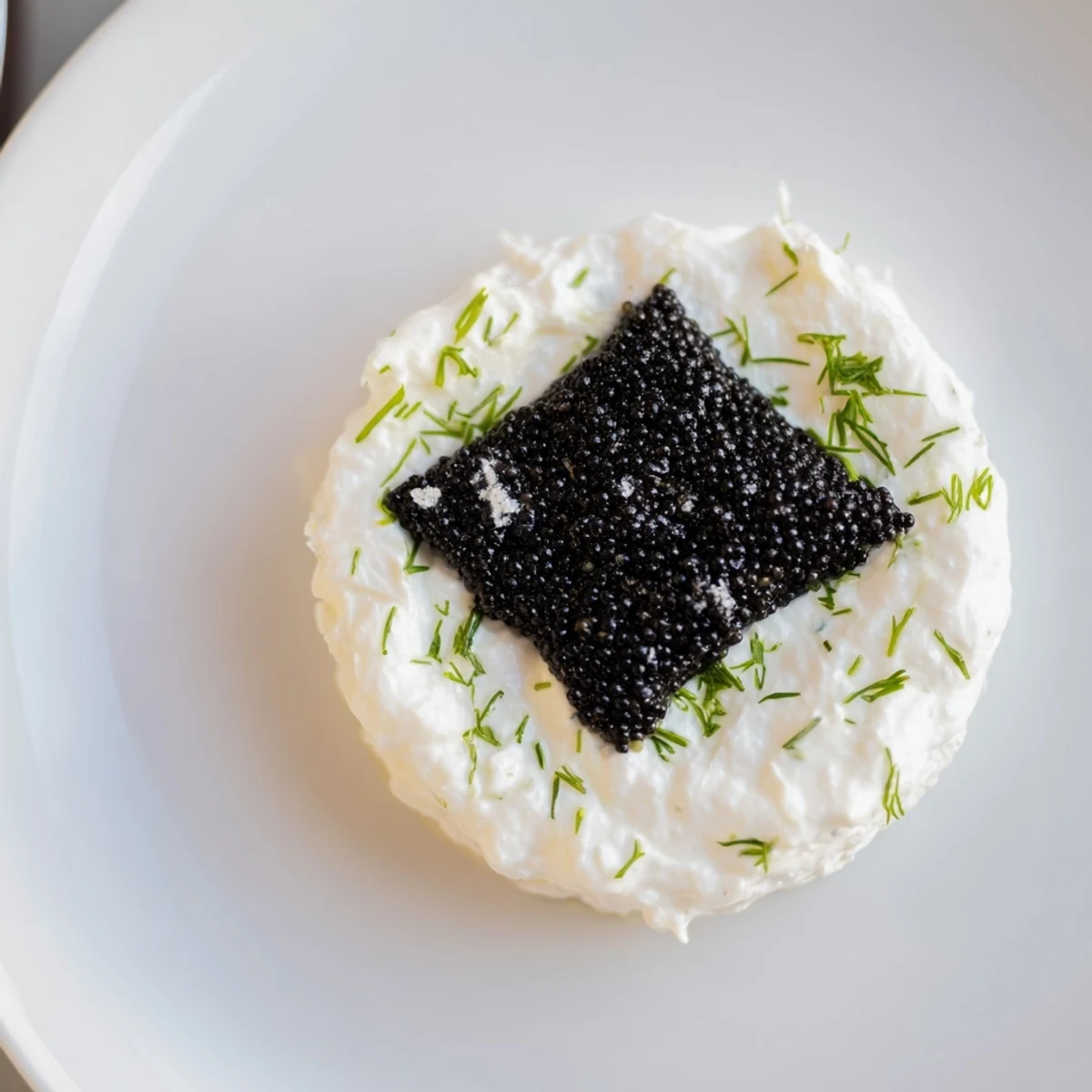 Elegant The Diamond Inlay appetizer featuring a creamy ring and luxurious diamond of caviar, ready to serve.