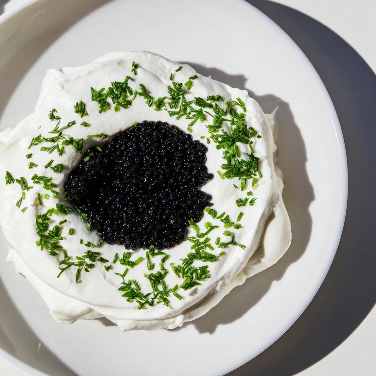 Enjoy fresh chives atop the creamy The Diamond Inlay, a pescatarian treat on a platter with crackers.