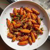 Golden-brown, caramelized honey soy roasted carrots, a vibrant and flavorful vegetarian side dish.