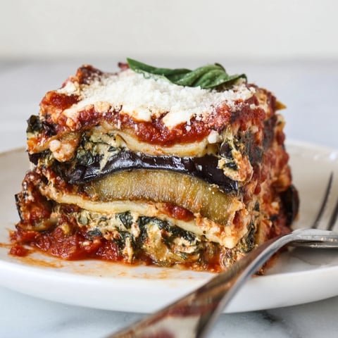 Golden, bubbly Cheesy Ricotta Eggplant Lasagna, a comforting bake with vibrant tomato sauce.