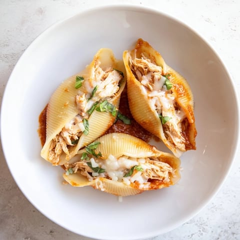 Creamy, baked Marry Me Chicken Stuffed Shells, a delicious Italian-American main course with vibrant red sauce.