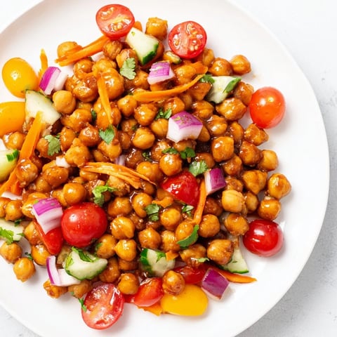 Smoky BBQ chickpea salad, a vibrant vegetarian meal, showcases colorful veggies and tangy dressing.