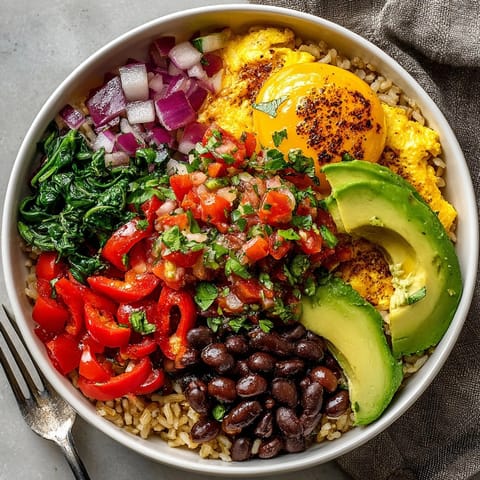 A close-up of a Breakfast Burrito Bowl showcasing fresh cilantro and creamy avocado slices.