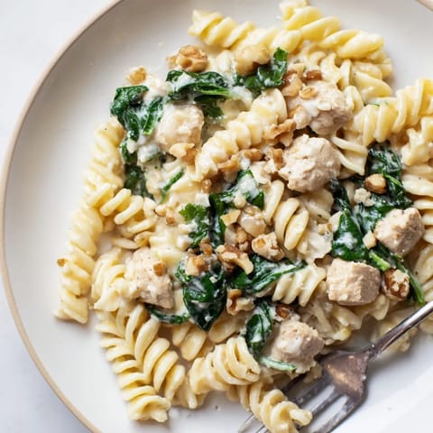 Delicious sautéed spinach and chicken in goat cheese pasta dish, perfect for dinner  