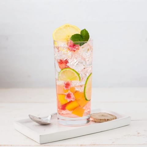 Hydrating mocktails blending flavored syrups with vibrant fruit slices and herbs for summer.  