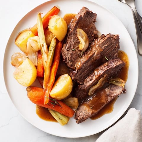 Hearty Sunday pot roast recipe served with savory, caramelized root vegetables.  