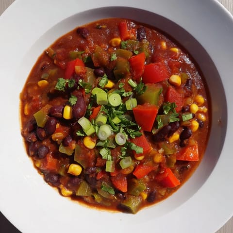 Hearty veggie chili topped with fresh cilantro, perfect for a cozy, flavorful meal tonight.