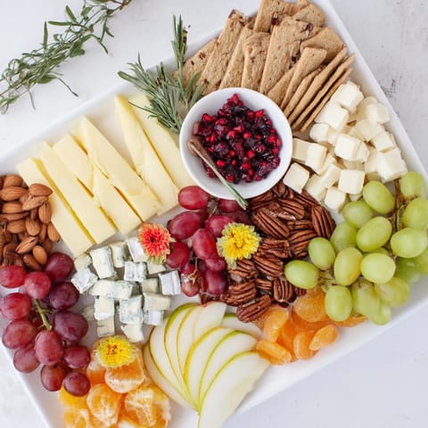 A beautifully arranged Winter Wonderland Grazing Tray, overflowing with colorful wintery treats and delicious cheese selections.