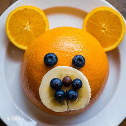 Adorable Orange Slice Bear Face Fruit Board, a fun and easy kids snack plate with coconut fur.