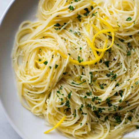 Elegant plate of Lemon Capellini, perfectly coated with a lemon butter sauce, ready to serve.
