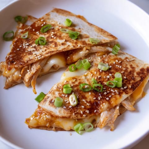 Crispy, golden-brown tortilla halves showcasing Korean BBQ Chicken Wrap Grilled Cheese's beautiful layers.