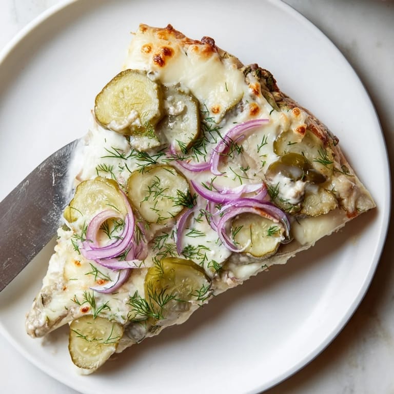 Deliciously unique Pickle Pizza, featuring gooey cheese and zesty flavors bursting through.  