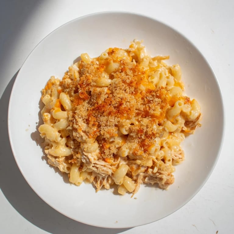 Golden-topped Classic Mac & Cheese with BBQ Chicken, a comforting casserole with smoky flavors.