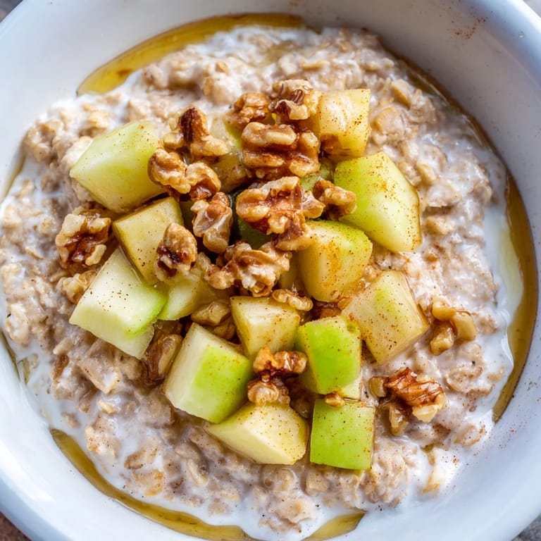 Delicious Apple Pie Oatmeal Bowl: a close-up revealing tender oats and glistening apple topping.
