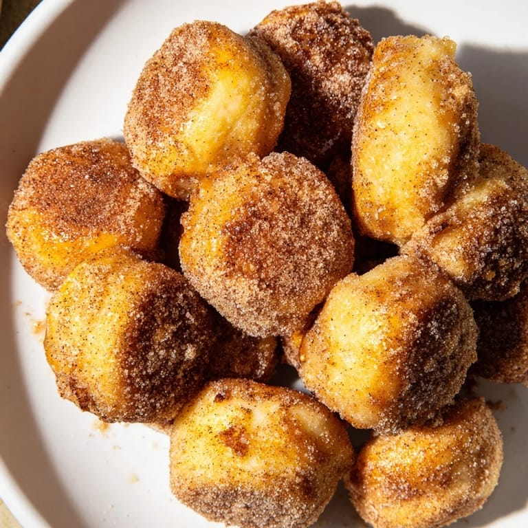 A close-up shot of freshly-made air fryer cinnamon donuts, invitingly soft and perfectly spiced.