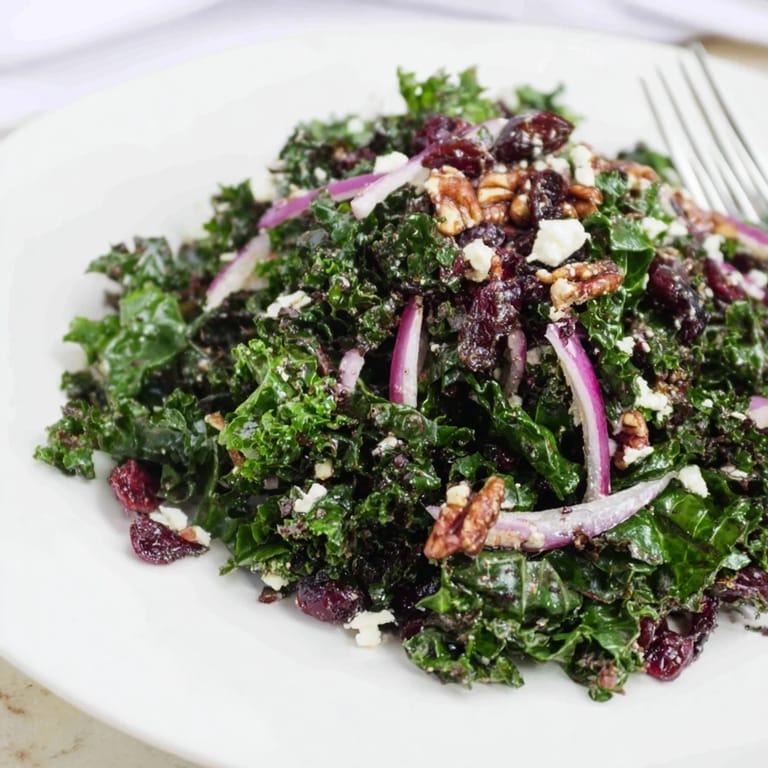Freshly massaged curly kale with toasted walnuts, red onion, and cranberries in a warm maple mustard vinaigrette.