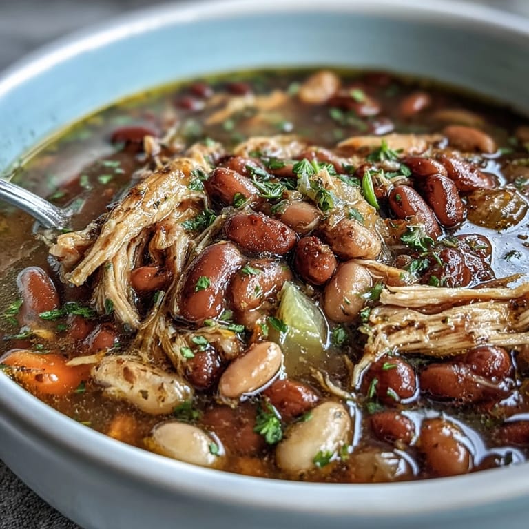 Rich, smoky aroma rises from a hearty slow-cooked soup packed with beans and shredded turkey.  